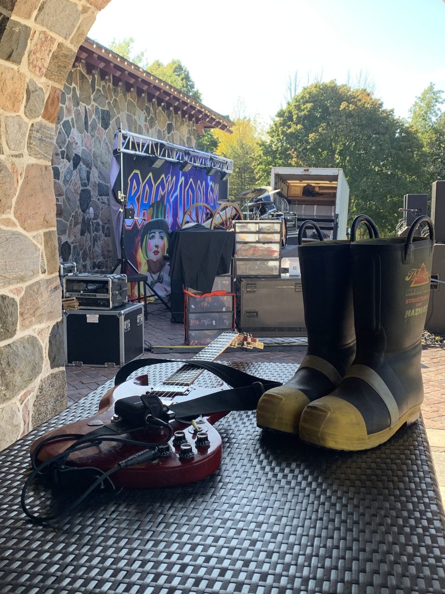 Fred's fire boots and a guitar beside the stage