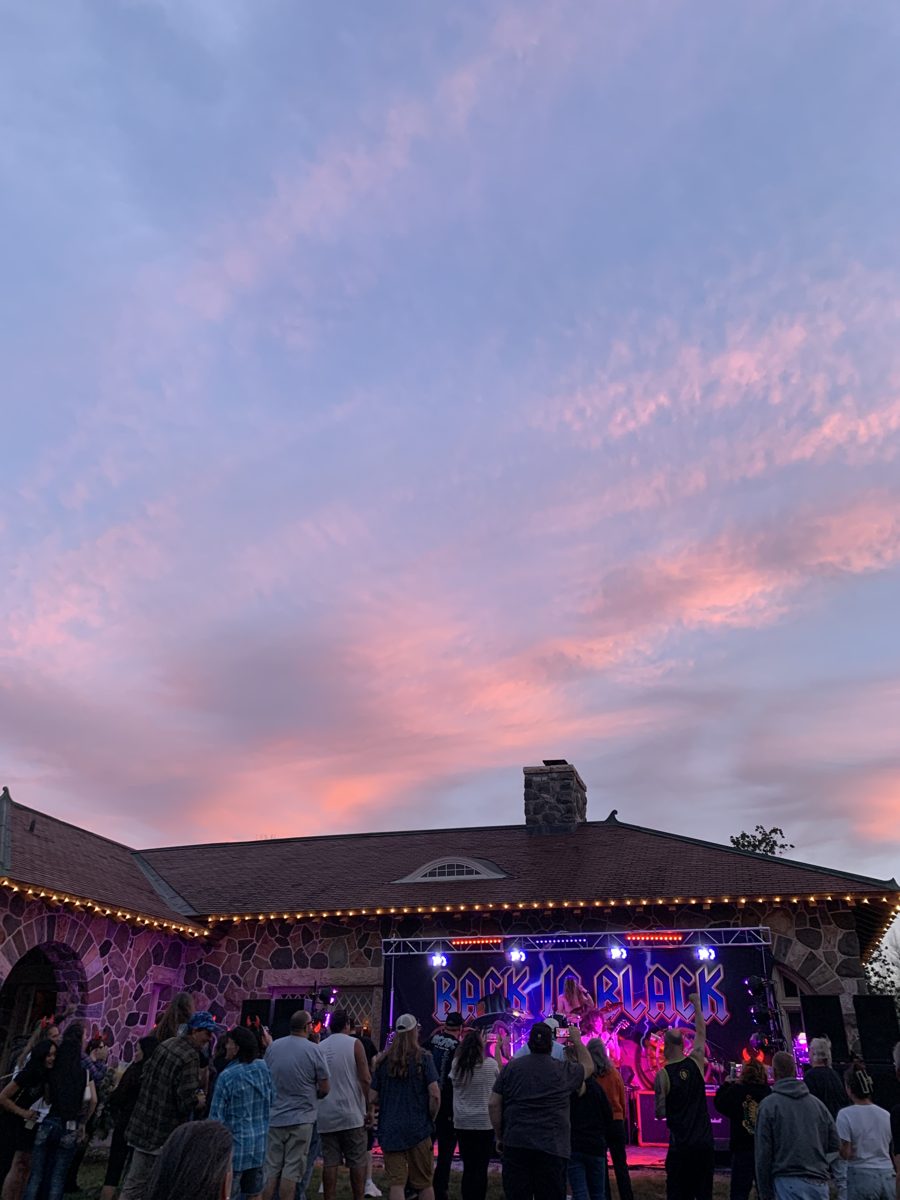 Crowd under a pink sunset as Back in Black plays